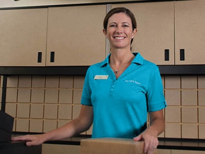 Stamps and postage Female associate with box